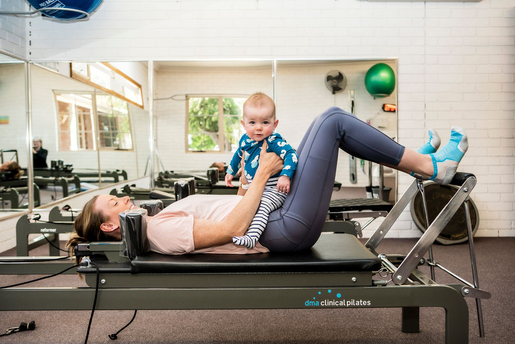 Mother with baby on reformer