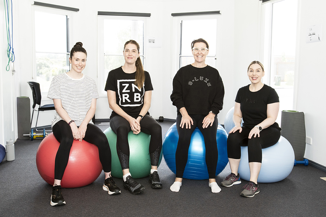 4 women sitting on exercise balls